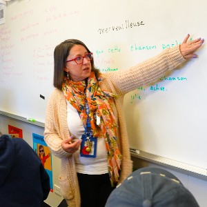 Tana Tornquist points to notes on a white board while teaching French at Rampart High School